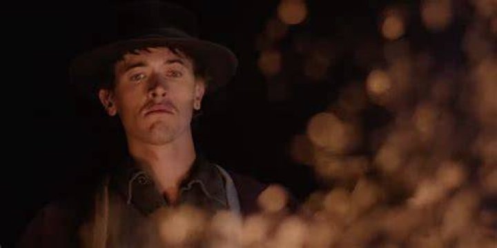 Billy the Kid looking into the fire