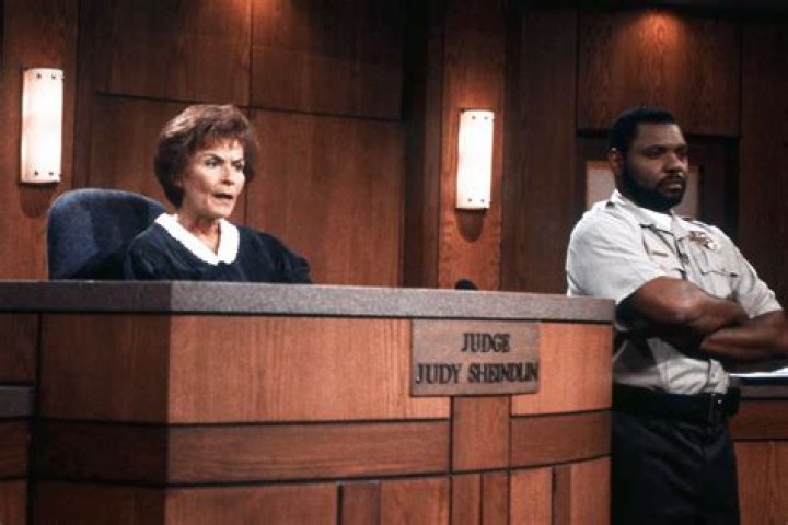 Byrd from Judge Judy wearing uniform and smiling