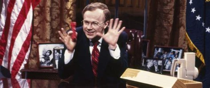 Dana Carvey dressed as George H.W. Bush and pointing in a sketch from Saturday Night Live.