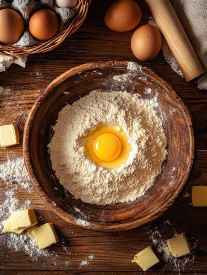 Flour egg and butter in a bowl Stock Photo Dissolve