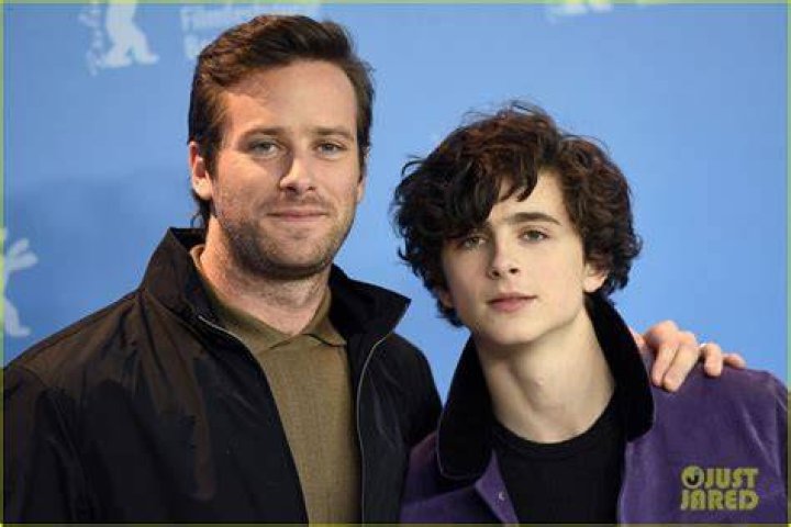 Hammer and Chalamet in Call Me By Your Name sitting at cafe chairs outside