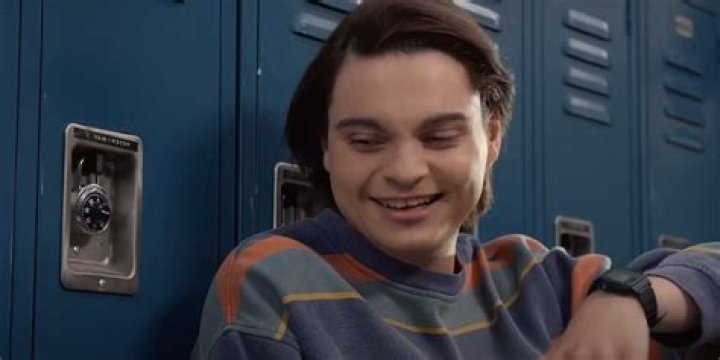 John laughing by the lockers in Ted