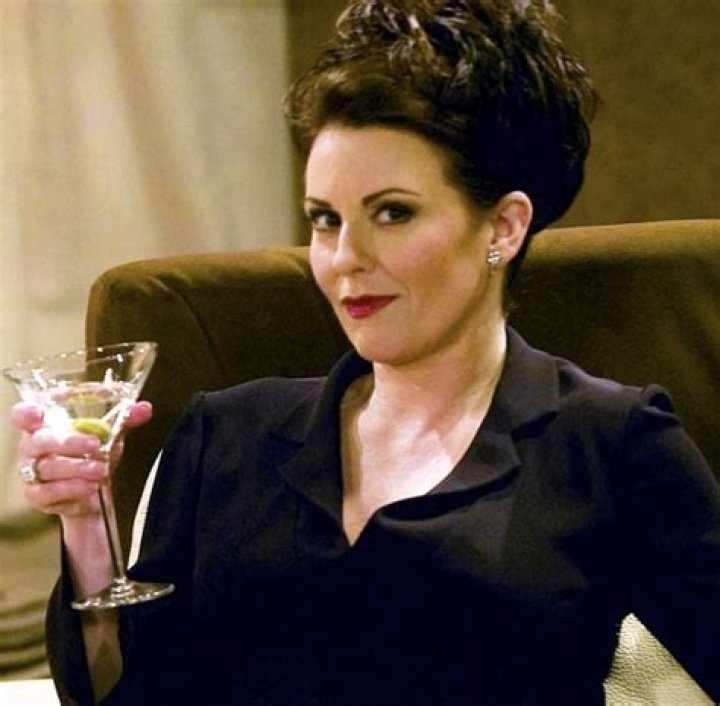 Karen Walker holding a glass of martini in Will and Grace