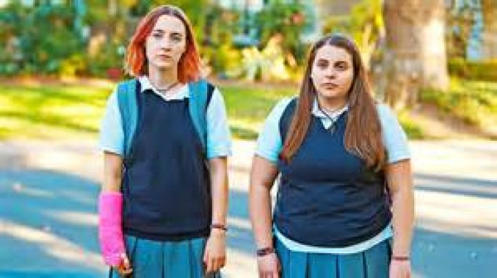 Lady Bird wearing pink cast and school uniform in Lady Bird