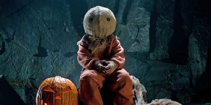 Sam sitting by a pumpkin in Trick 'r Treat.