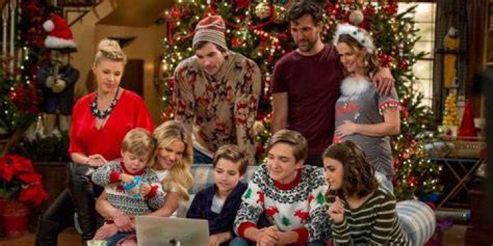 The entire Fuller/Tanner/Gimbler clan curled up in Christmas clothes around a laptop