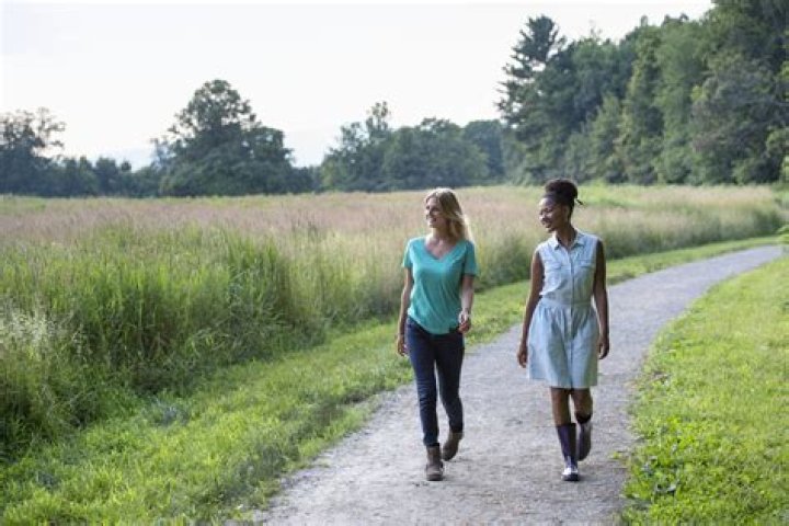 Two women on a path among trees in Tidelands