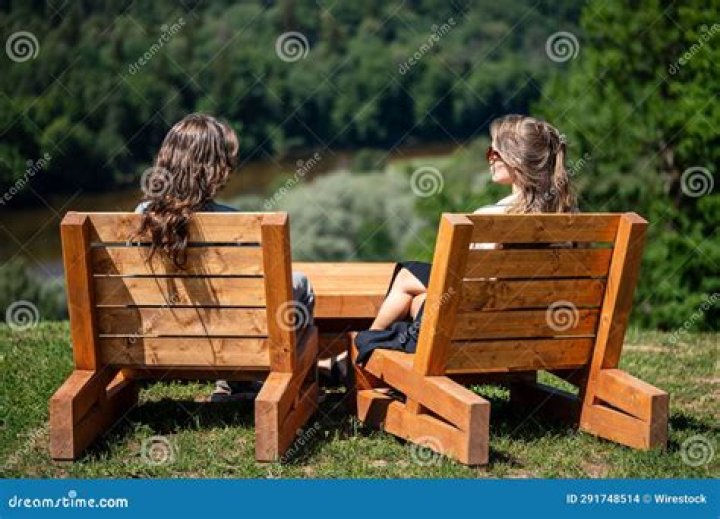 Two young women sitting in a boat with their diving gear in Dive Club